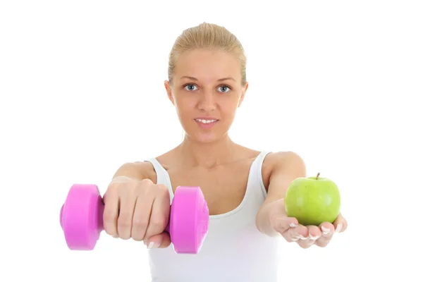 Young woman with dumbbell and apple — Photo