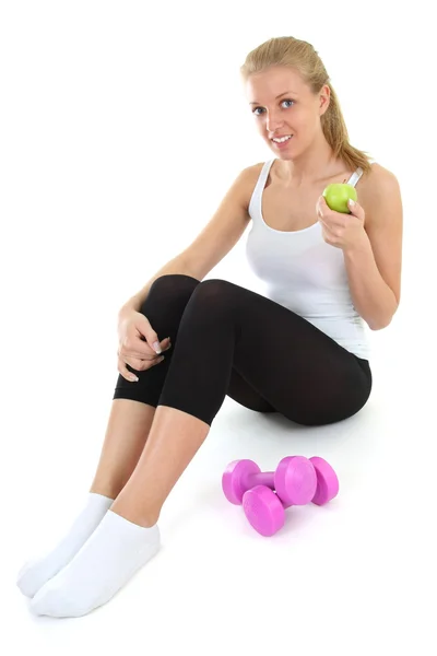 Young blondie woman sitting with dumbbells and apple — Stock Photo, Image