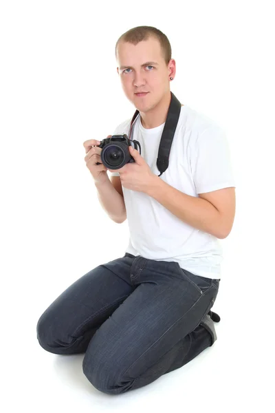Ung fotograf med kamera sitter — Stockfoto