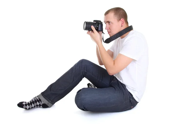 Muž s Foto fotoaparát sezení — Stock fotografie