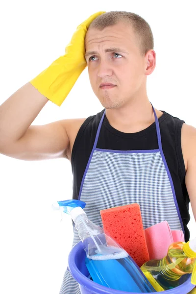 Tired man in apron with cleaning supplies — Stock Photo, Image
