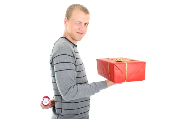 Man with gift and wedding ring winking — Stock Photo, Image