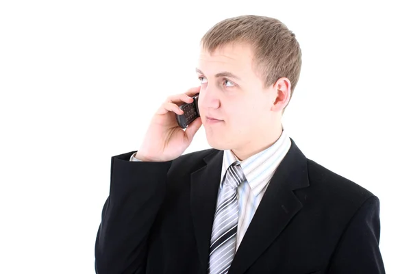 Mladý podnikatel v černém obleku s telefonem — Stock fotografie