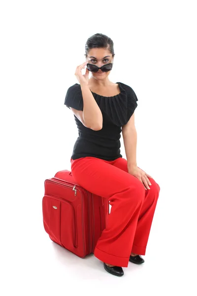 Businesswoman sitting on big suitcase — Stock Photo, Image