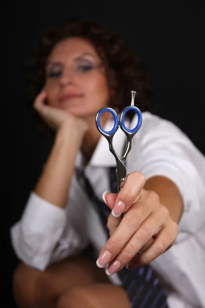 Woman with scissors over black — Fotografia de Stock
