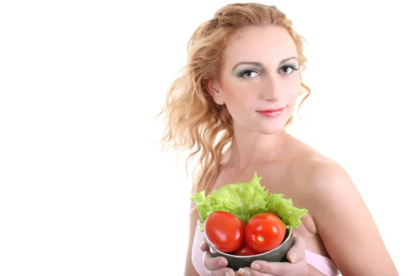Jovem mulher com salada verde, um tomate — Fotografia de Stock