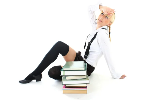 Unavený školačka sedí s knihami — Stock fotografie