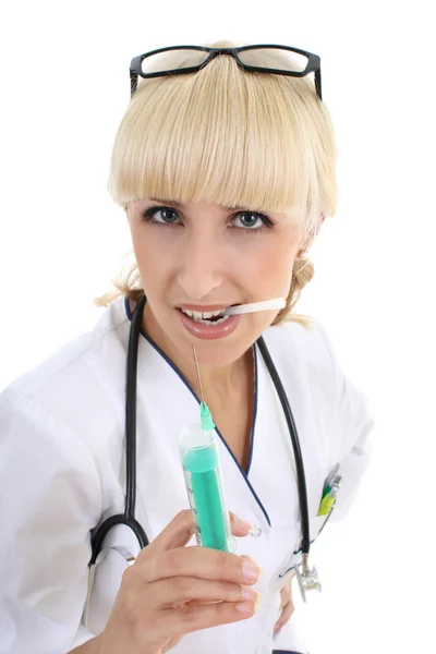 Doctor woman in gown with syringe over white — Stok Foto