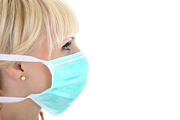 Profile of surgeon woman in mask over white — Stok Foto