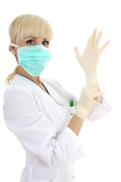 Surgeon woman in mask and rubber gloves over white — Stok Foto