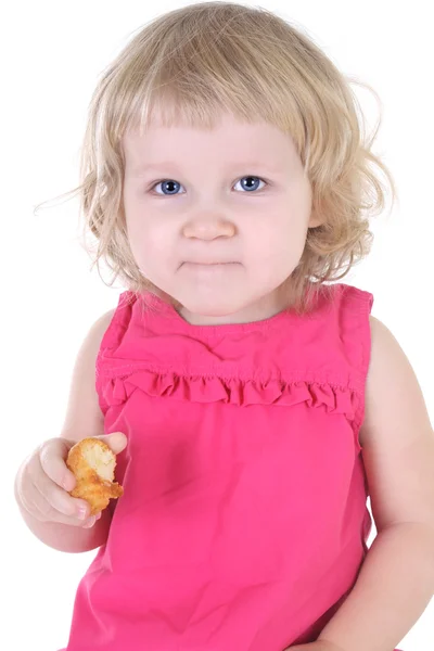 Kleine Mädchen im rosa Kleid mit muffin — Stockfoto