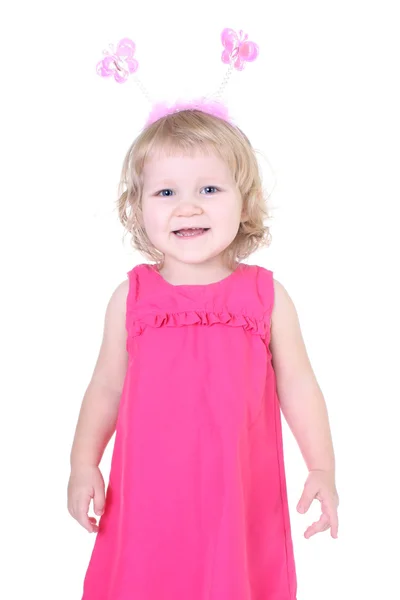 Маленькая девочка в розовом платье с рогами — стоковое фото
