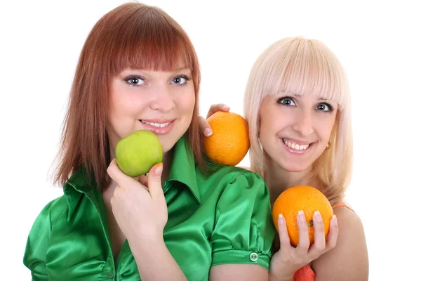 Twee jonge aantrekkelijke vrouwen met groene appel en sinaasappelen Rechtenvrije Stockfoto's