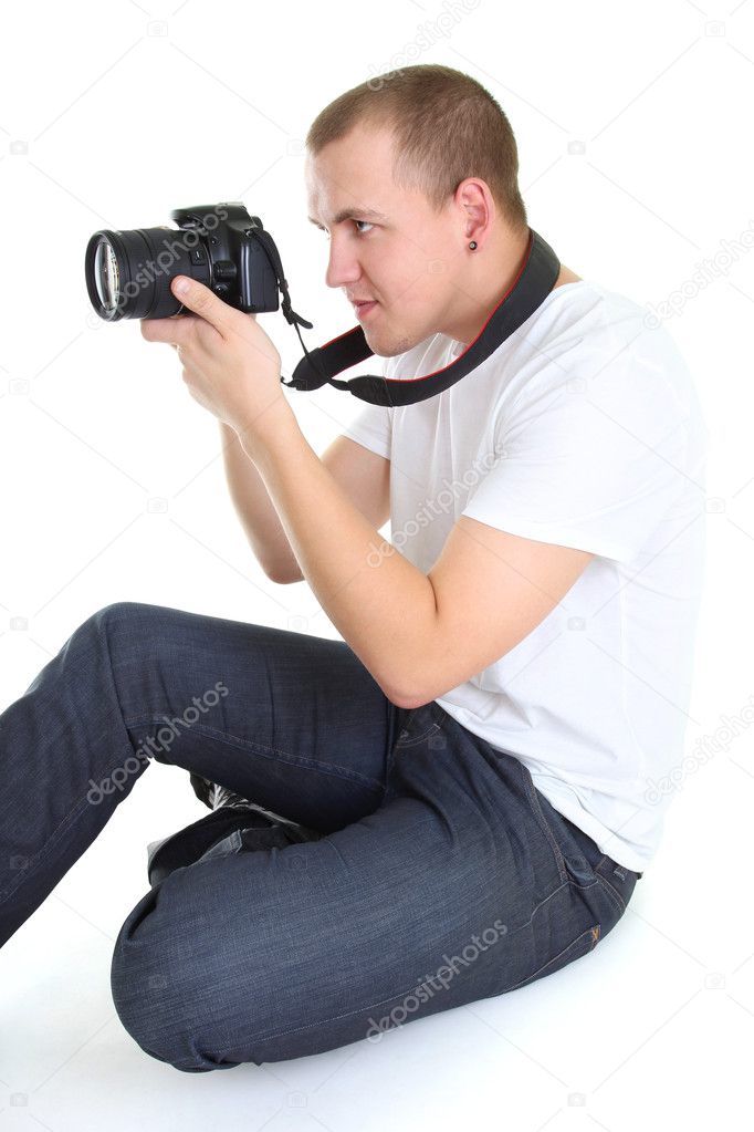 Photographer with dslr camera sitting isolated over white