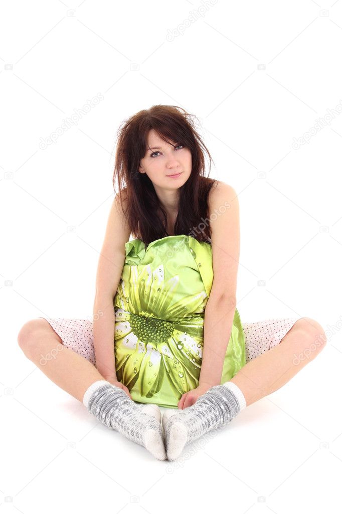 Sleepy woman in pajamas sitting with pillow