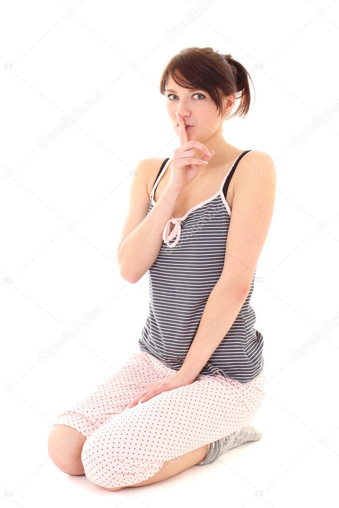 Girl in pajamas showing shhh sign