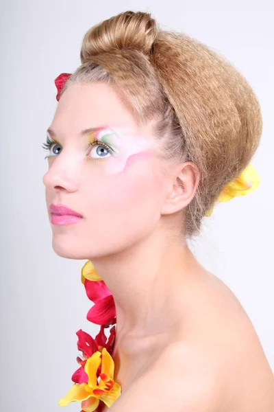 Mujer hermosa con maquillaje creativo y flores — Foto de Stock