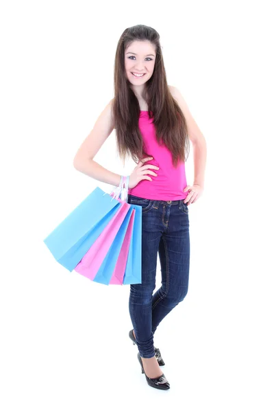 Happy teenager in pink t-shirt with shopping bags — Stock Photo, Image