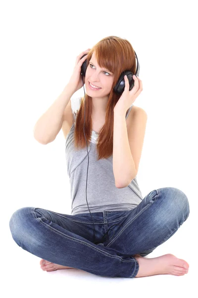 Happy teenager with headphones sitting — Stock Photo, Image