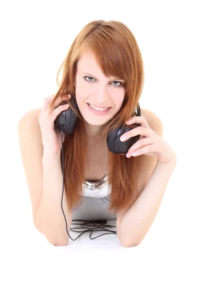 Happy teenager with headphones lying — Stock Photo, Image