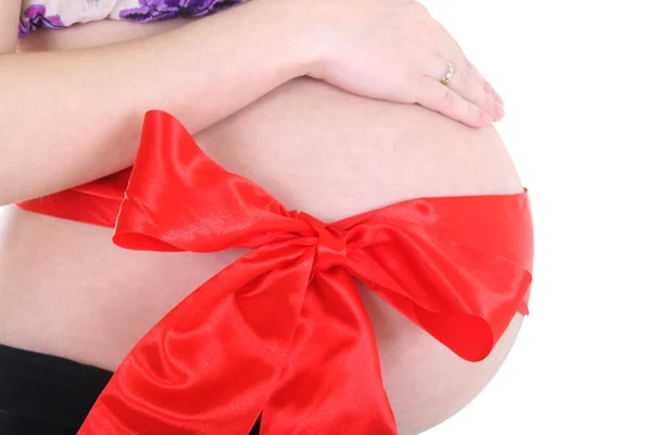 Belly with red ribbon over white — Stock Photo, Image