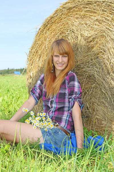 Woman in a field with hay bales Royalty Free Stock Images
