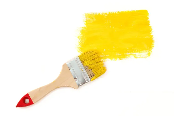 Yellow paint with brush — Stock Photo, Image
