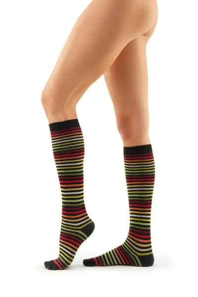 Legs long female in striped socks — Stock Photo, Image