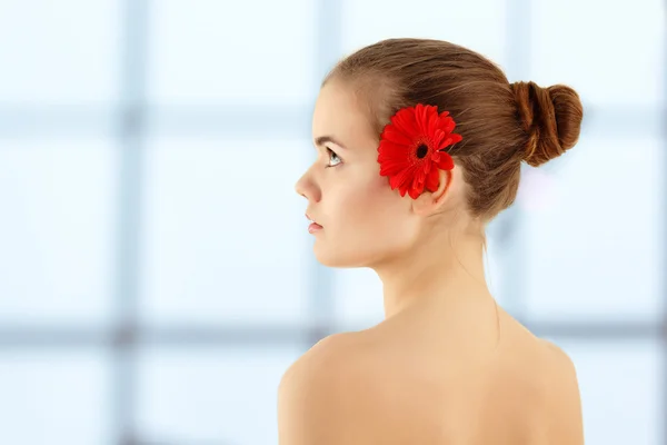 Spa beautiful teenager girl with flower in profile — Stock Photo, Image