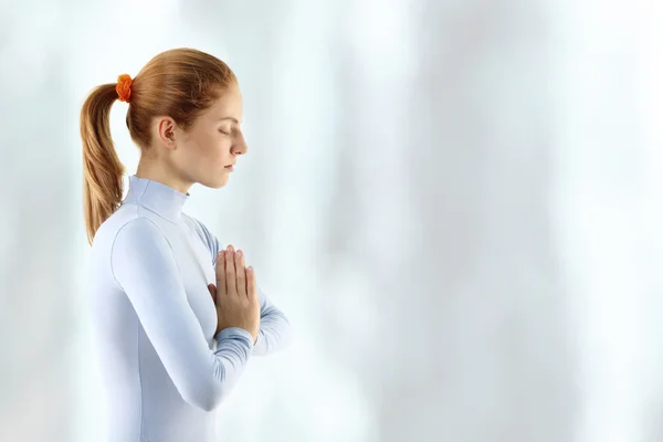Young woman meditate over waterfall Stock Photo