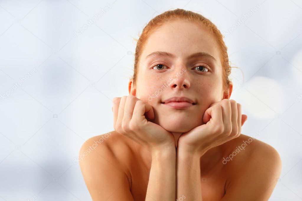Woman young beautiful touching face with her hand