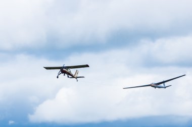 Glider in tow in the sky clipart