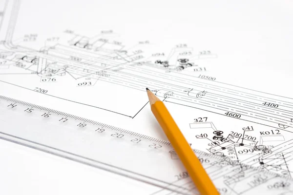 Yellow pencil on the line, and drawings on the table — Stock Photo, Image