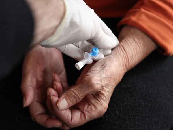 stock image Close up of old hands with tablets