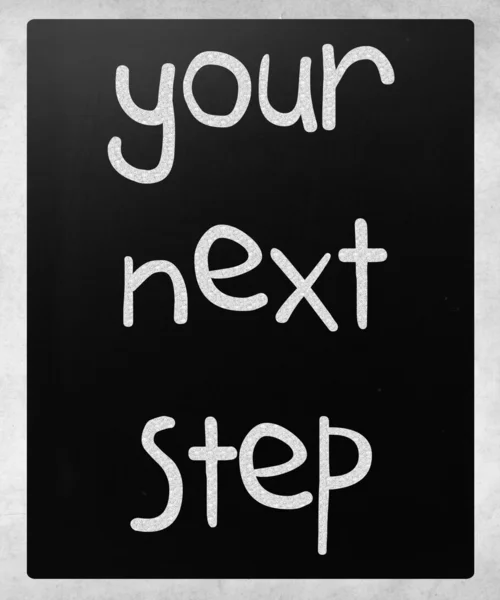 "Your next step" handwritten with white chalk on a blackboard — Stock Photo, Image