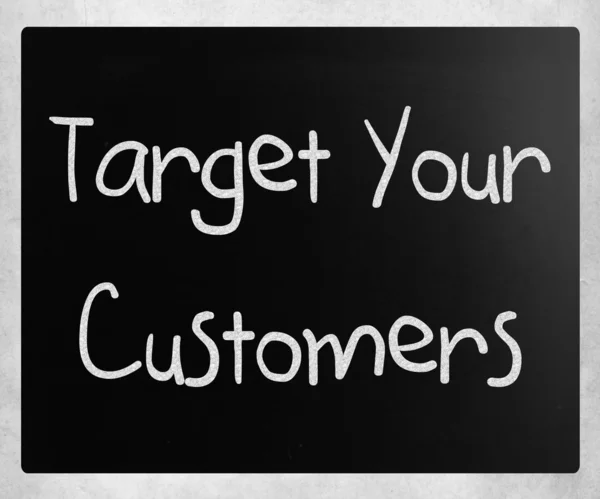 "Target your customers" handwritten with white chalk on a blackb — Φωτογραφία Αρχείου