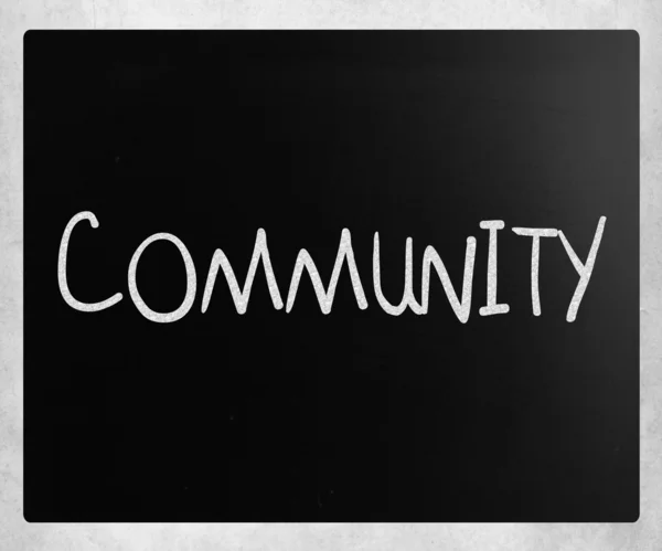 "Společenství "psáno bílou křídou na tabuli — Stock fotografie