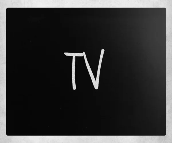 "TV" handwritten with white chalk on a blackboard — Stock Photo, Image