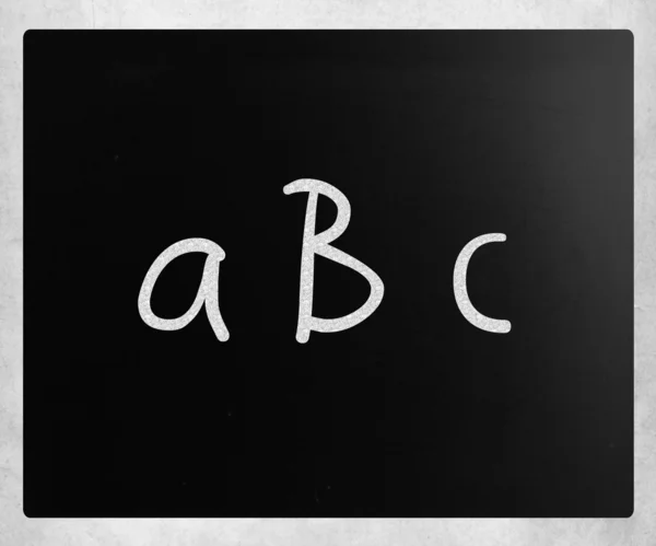 "ABC "handwritten with white chalk on a blackboard — стоковое фото