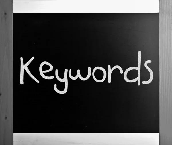 The word "Keywords" handwritten with white chalk on a blackboard — Stock Photo, Image