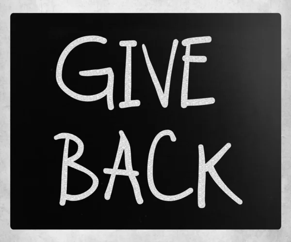 "Give back "handwritten with white chalk on a blackboard — стоковое фото