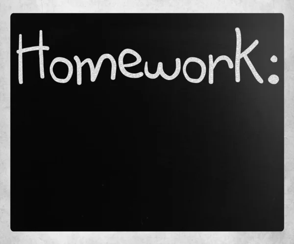 "Homework "handwritten with white chalk on a blackboard — стоковое фото