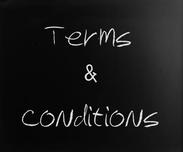 "Terms & Conditions "handwritten with white chalk on a blackboar — стоковое фото