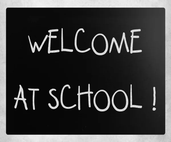 "Welcome at school" handwritten with white chalk on a blackboard — Stock Photo, Image