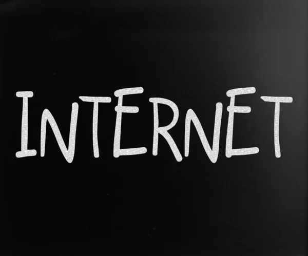 Het woord 'internet' handgeschreven met wit krijt op een schoolbord — Stockfoto