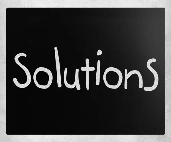"Solutions" handwritten with white chalk on a blackboard — Stock Photo, Image