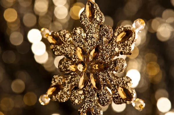 Artificial Snowflake in gold Stock Picture