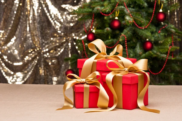 Three presents with gold ribbon — Stock Photo, Image