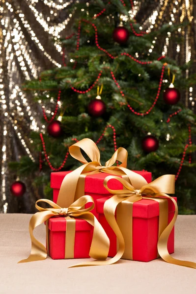 Three presents with gold ribbon — Stock Photo, Image