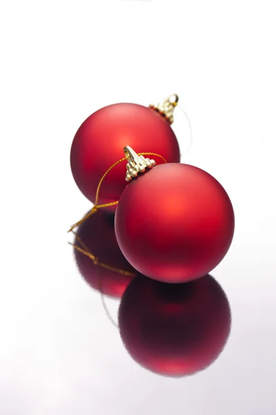 Christmas baubles on a silver reflective surface — Stock Photo, Image